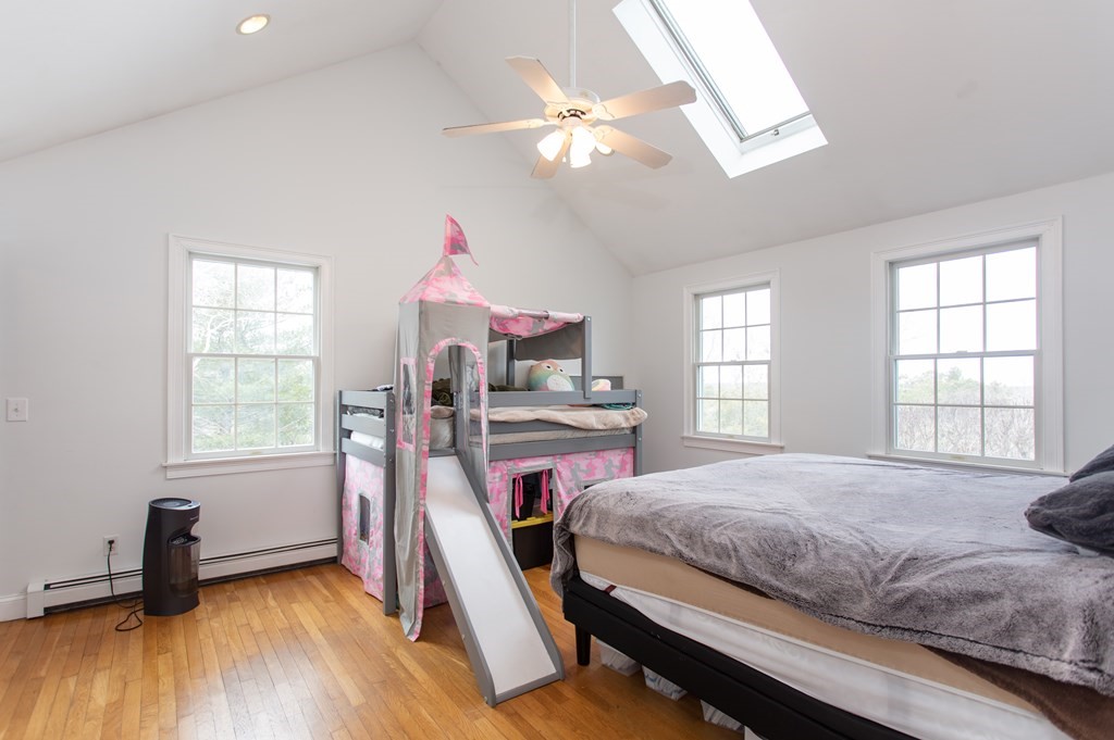 2 Desmond Road Bourne, MA 02561 - Photo 8 of 26 a bedroom with a bed and a chandelier