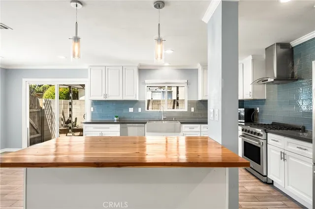 a kitchen with kitchen island granite countertop a sink appliances and cabinets
