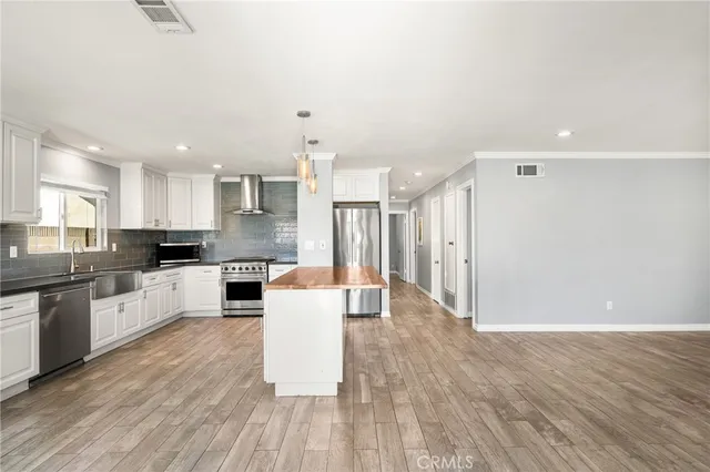 a large kitchen with a table and chairs