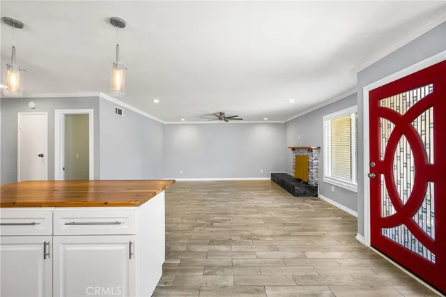 a kitchen with stainless steel appliances granite countertop a sink and wooden floor