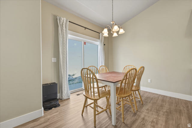 45 Memory Lane Tooele, UT 84074 - Photo 10 of 30 Dining room with suspended lighting, light wood-style floors, and lofted ceiling