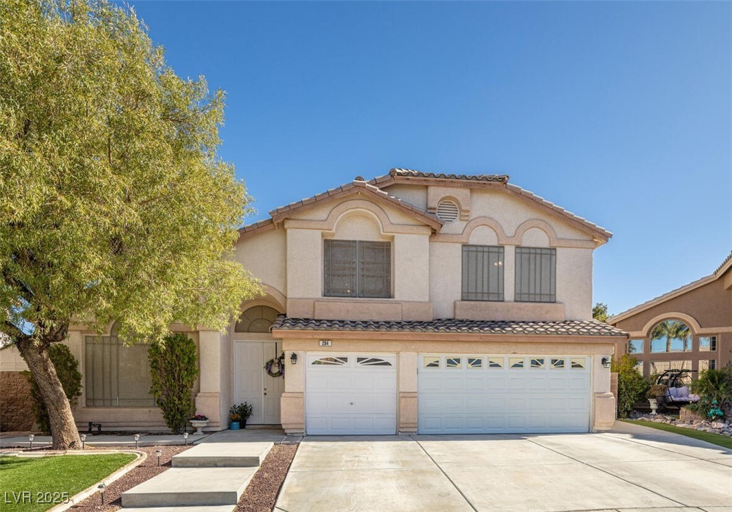 284 Pointe Ranier Avenue Henderson, NV 89012 - Photo 1 of 39 Mediterranean / spanish-style home with a tiled roof, an attached garage, stucco siding, and concrete driveway