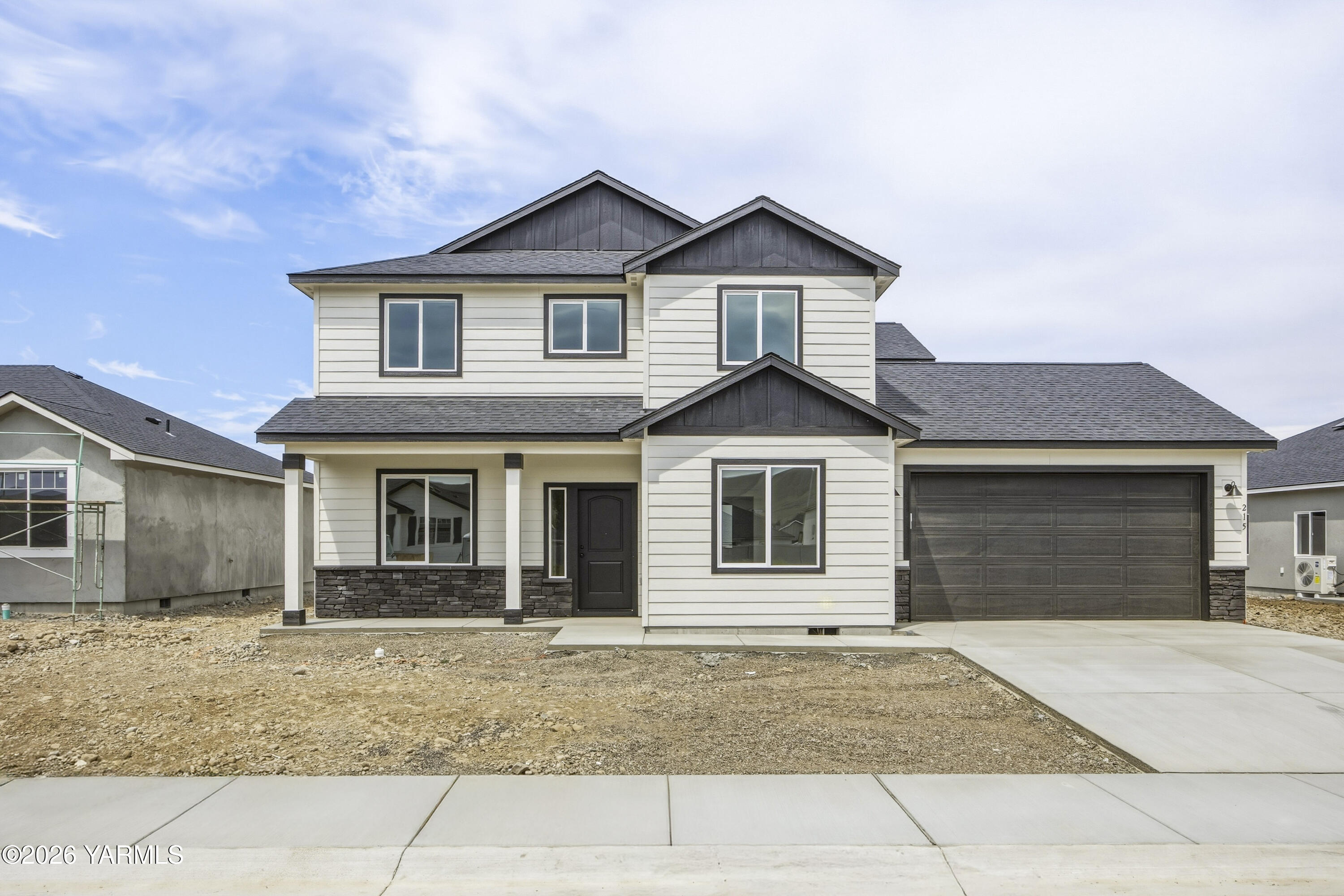 a front view of a house with garage and yard