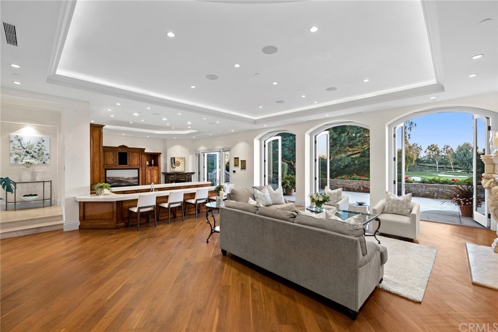 3 Burning Tree Circle Newport Beach, CA 92660 - Photo 12 of 65 a living room with furniture and a wooden floor