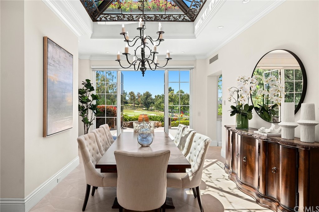 3 Burning Tree Circle Newport Beach, CA 92660 - Photo 18 of 65 a view of a dining room with furniture a chandelier and wooden floor