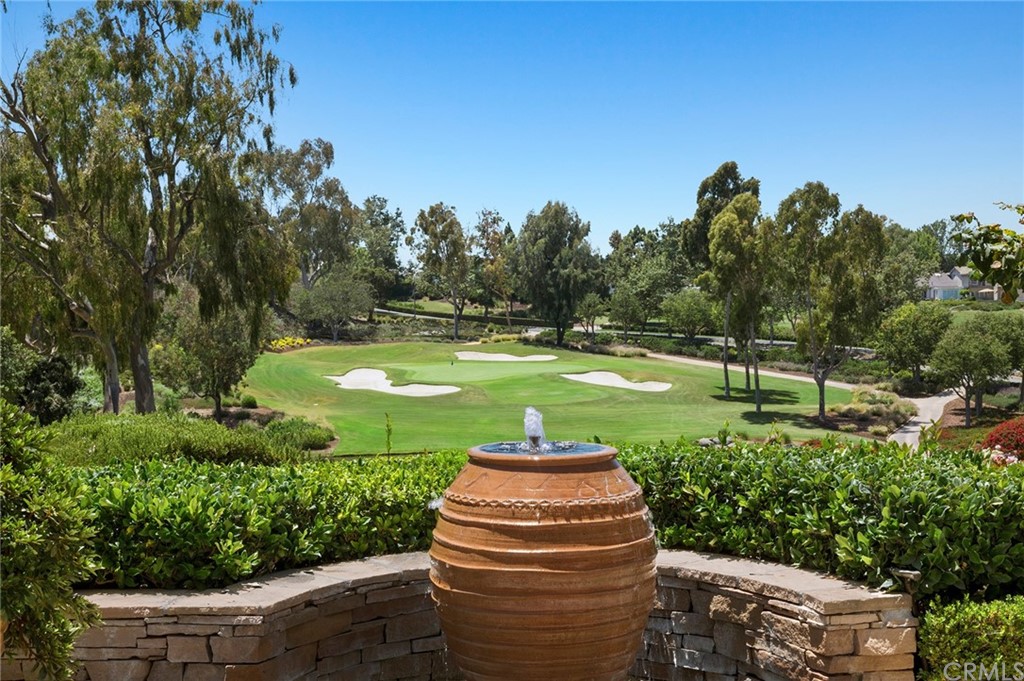 3 Burning Tree Circle Newport Beach, CA 92660 - Photo 2 of 65 a view of a garden with a fountain
