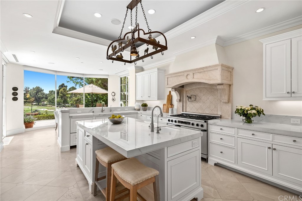 3 Burning Tree Circle Newport Beach, CA 92660 - Photo 21 of 65 a kitchen with a counter space a sink appliances and cabinets