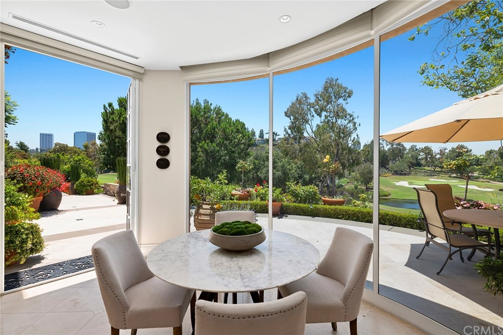 3 Burning Tree Circle Newport Beach, CA 92660 - Photo 24 of 65 a view of a patio with table and chairs potted plants with wooden floor and fence