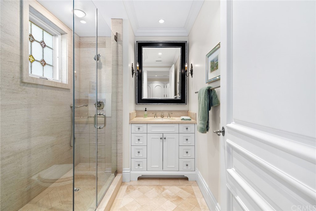 3 Burning Tree Circle Newport Beach, CA 92660 - Photo 32 of 65 a bathroom with a shower sink and mirror