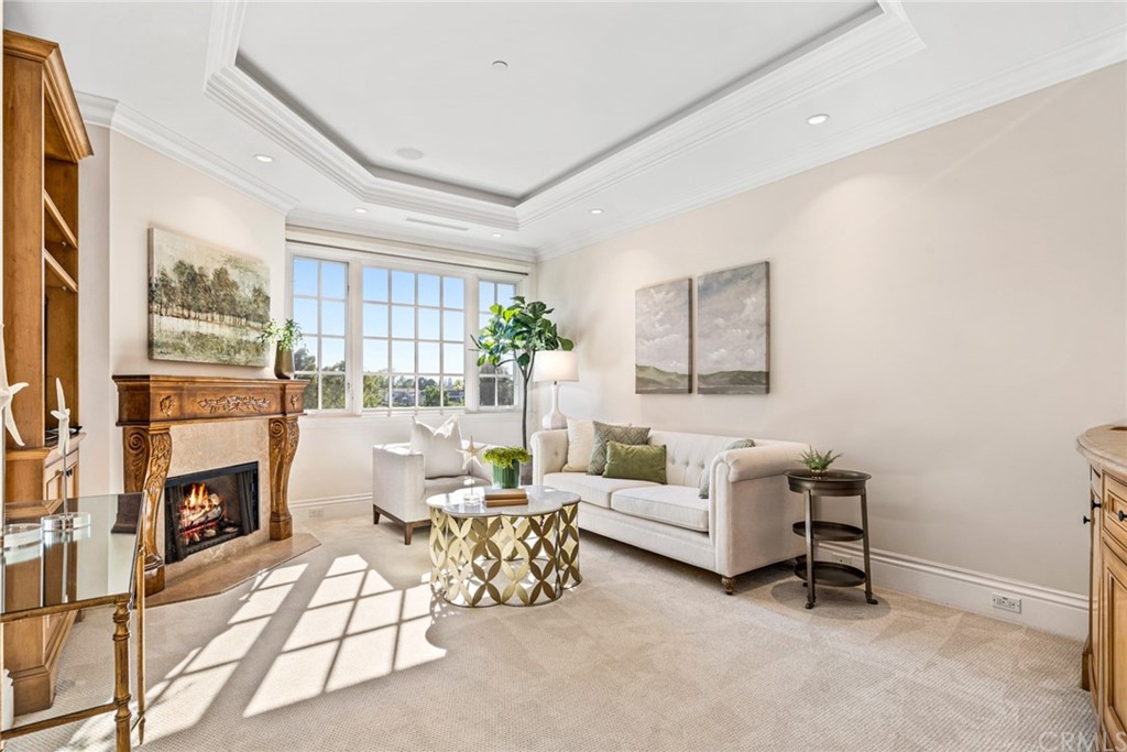 3 Burning Tree Circle Newport Beach, CA 92660 - Photo 37 of 65 a living room with furniture and a fireplace