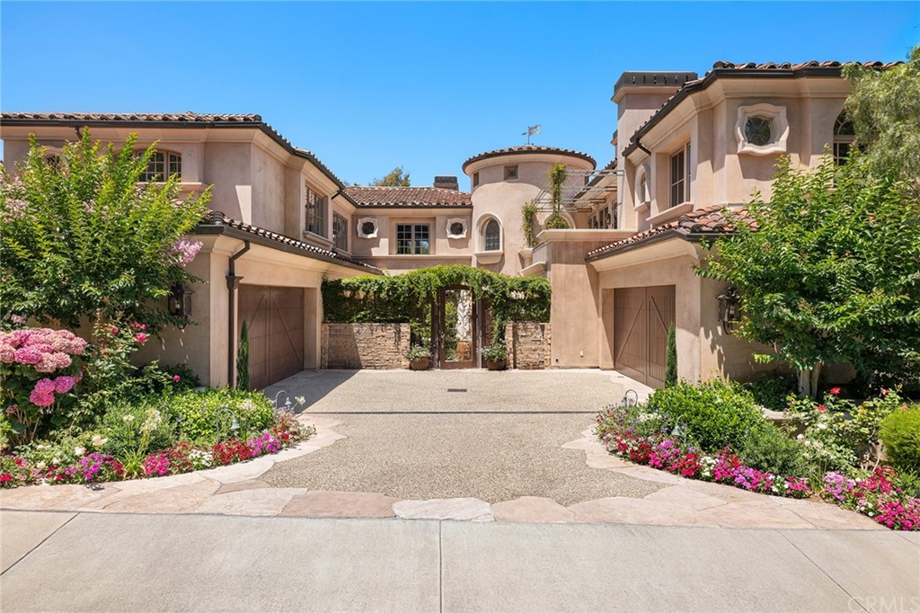 3 Burning Tree Circle Newport Beach, CA 92660 - Photo 4 of 65 a front view of a house with a garden