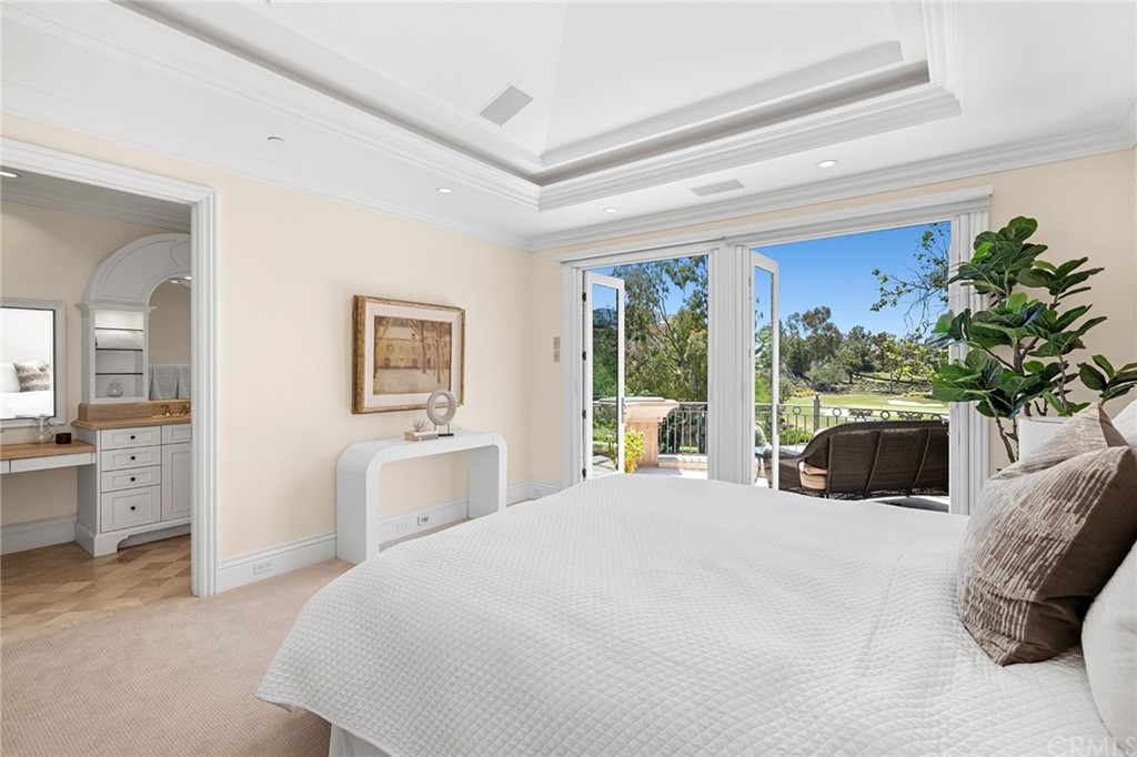 3 Burning Tree Circle Newport Beach, CA 92660 - Photo 44 of 65 a bedroom with a large bed and a potted plant