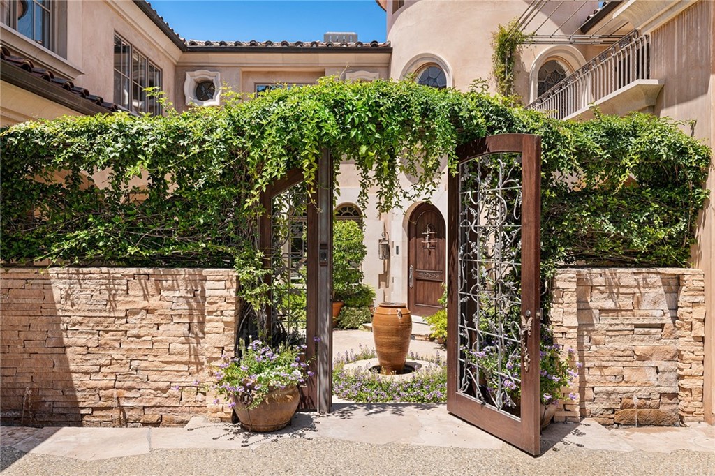 3 Burning Tree Circle Newport Beach, CA 92660 - Photo 5 of 65 a front view of a building with a garden