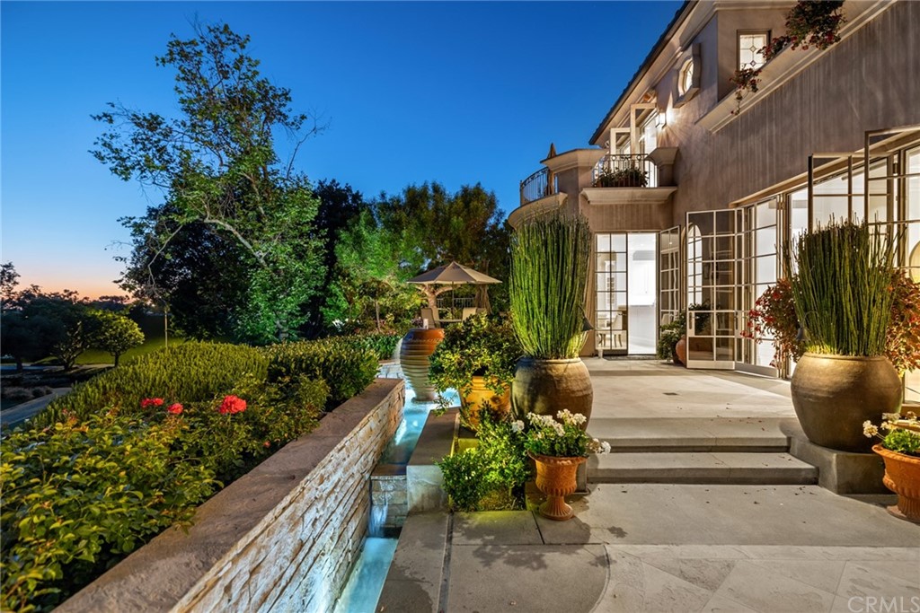 3 Burning Tree Circle Newport Beach, CA 92660 - Photo 58 of 65 a front view of a house with a yard