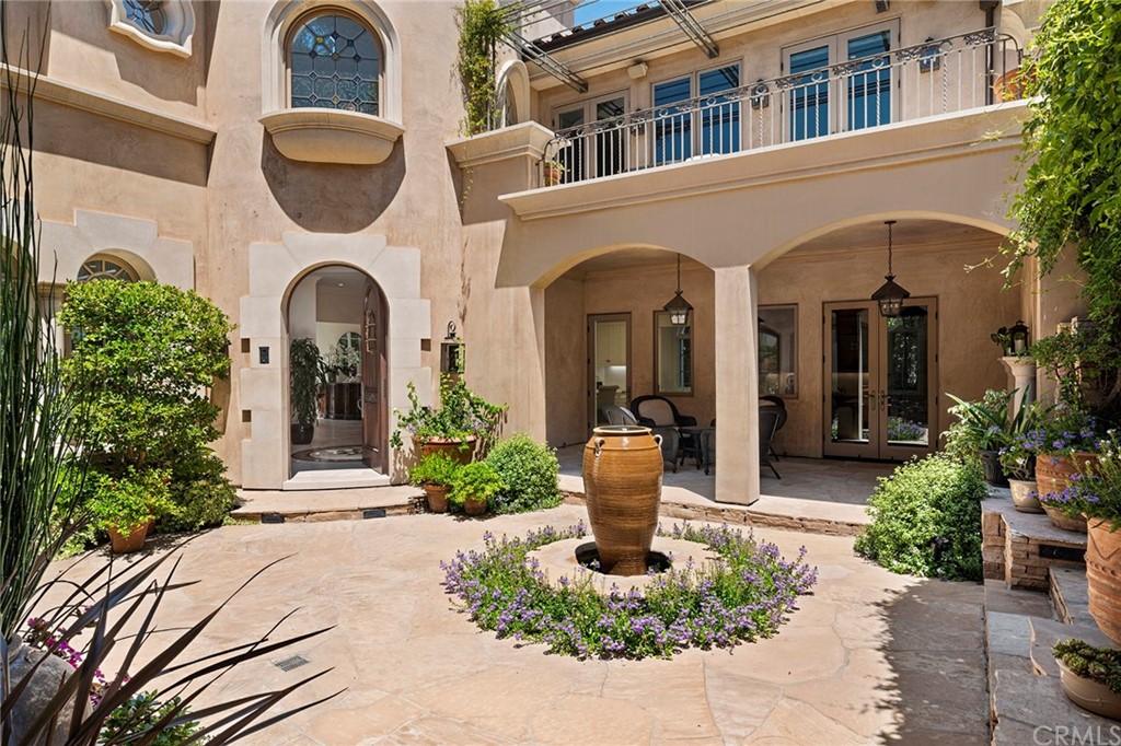 3 Burning Tree Circle Newport Beach, CA 92660 - Photo 6 of 65 a front view of a house with a porch