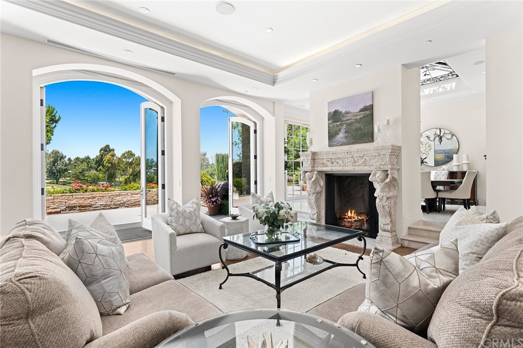 3 Burning Tree Circle Newport Beach, CA 92660 - Photo 10 of 65 a living room with furniture and a fireplace