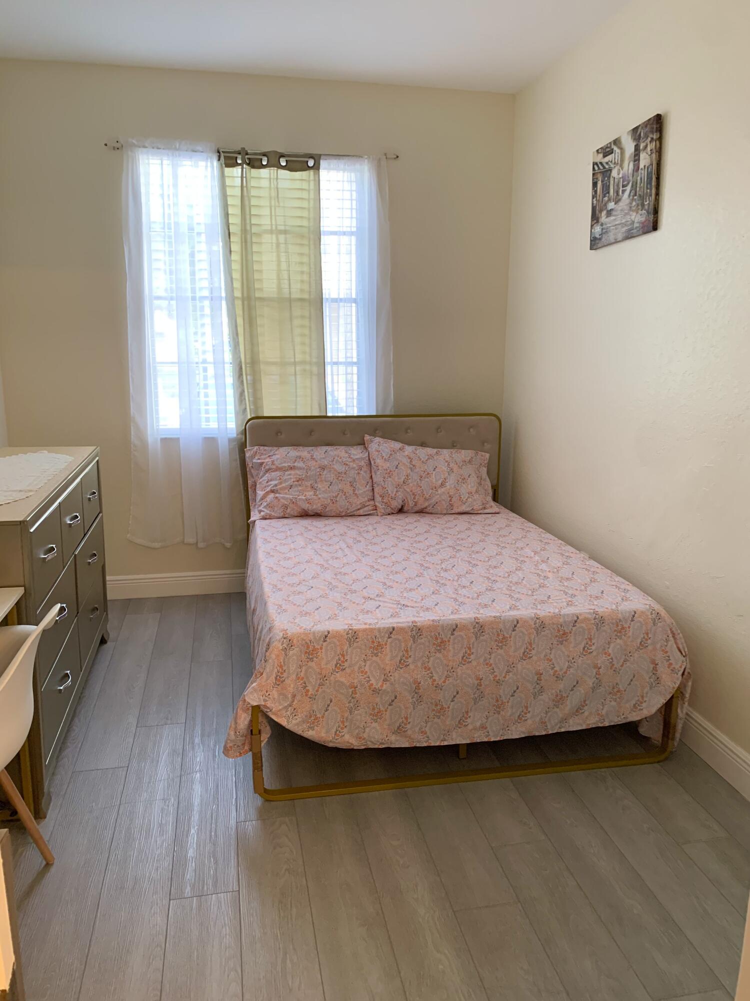 2007 Nassau Drive Riviera Beach, FL 33404 - Photo 12 of 13 a bedroom with a bed and wooden floor