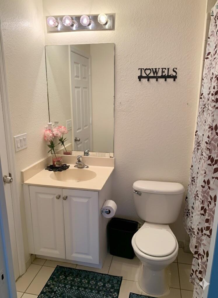2007 Nassau Drive Riviera Beach, FL 33404 - Photo 13 of 13 a bathroom with a sink a toilet and a mirror