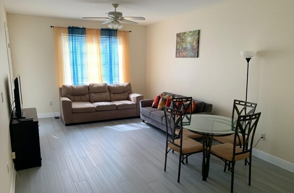 2007 Nassau Drive Riviera Beach, FL 33404 - Photo 6 of 13 a living room with furniture and a wooden floor