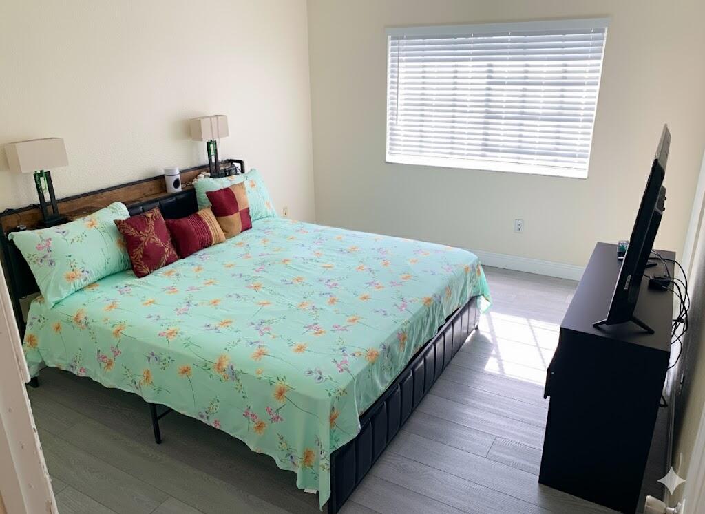 2007 Nassau Drive Riviera Beach, FL 33404 - Photo 7 of 13 a bedroom with a bed a dresser and a window