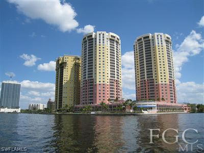 a view of a tall building next to a lake