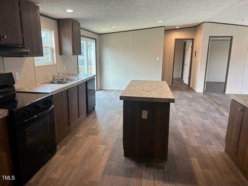 3330 North McCullen Road Faison, NC 28341 - Photo 12 of 31 a kitchen with a sink a counter top space and cabinets