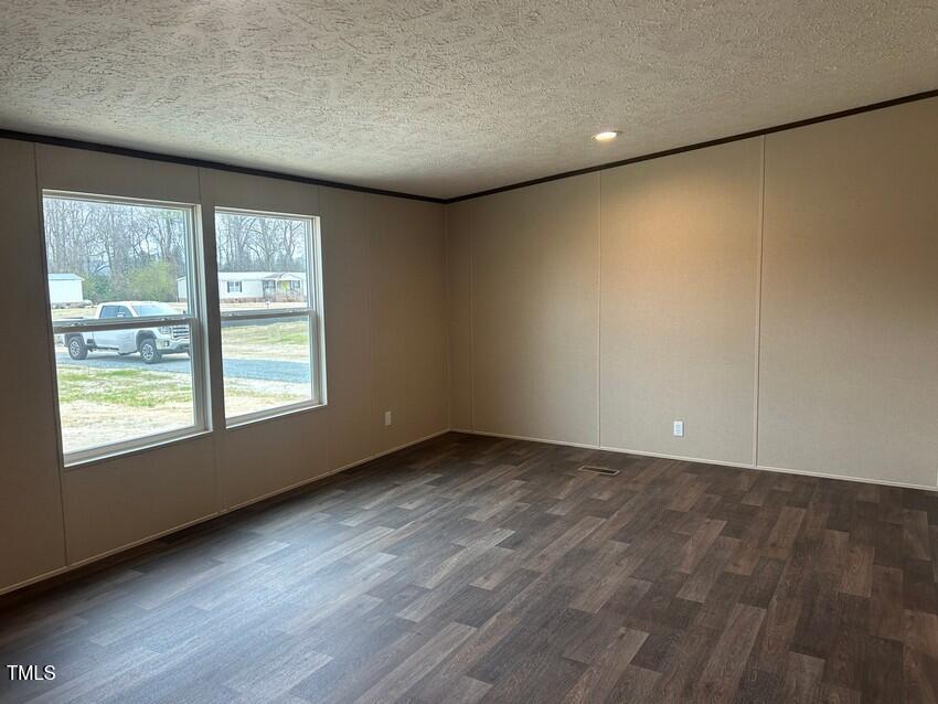 3330 North McCullen Road Faison, NC 28341 - Photo 14 of 31 an empty room with wooden floor and windows