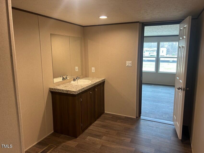 3330 North McCullen Road Faison, NC 28341 - Photo 18 of 31 a bathroom with a sink and a mirror