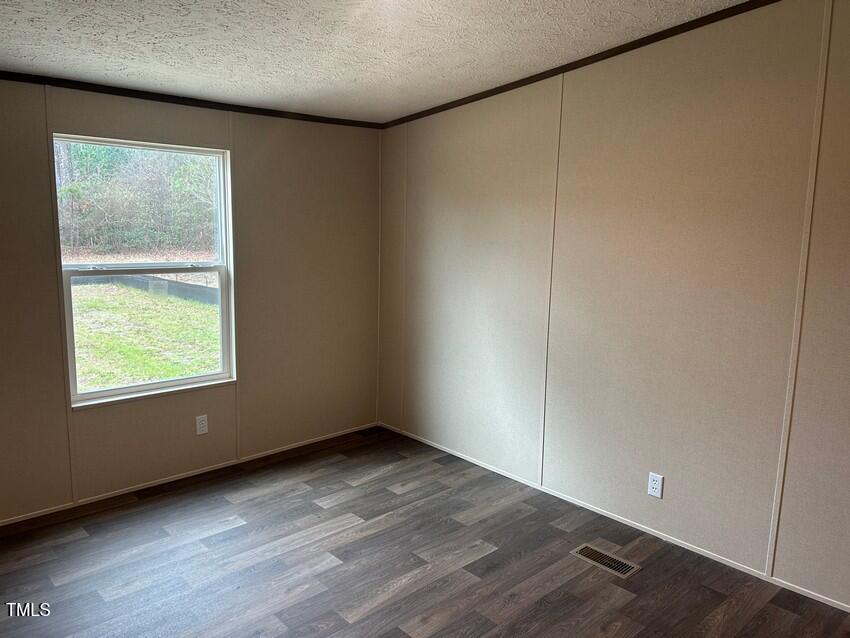 3330 North McCullen Road Faison, NC 28341 - Photo 23 of 31 an empty room with wooden floor and windows