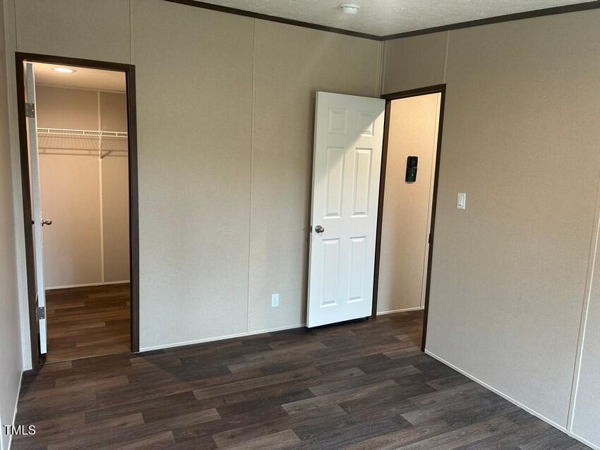 3330 North McCullen Road Faison, NC 28341 - Photo 24 of 31 a view of an empty room with wooden floor and closet