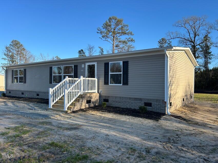 3330 North McCullen Road Faison, NC 28341 - Photo 27 of 31 a view of a house with a yard and wooden fence
