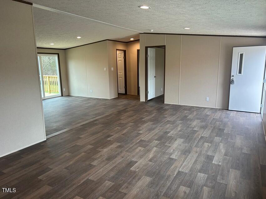 3330 North McCullen Road Faison, NC 28341 - Photo 6 of 31 a view of an empty room with wooden floor and a window