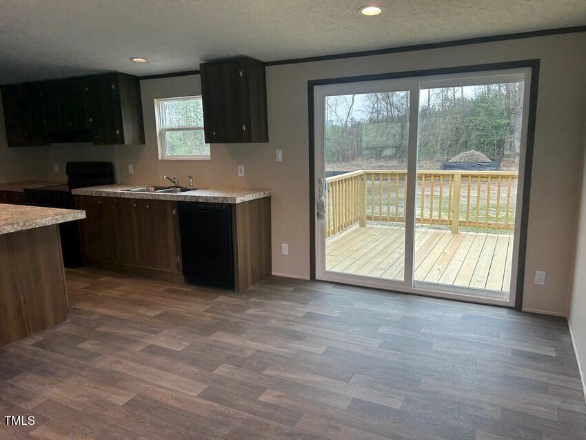 3330 North McCullen Road Faison, NC 28341 - Photo 8 of 31 a view of an empty room with a kitchen and a large window