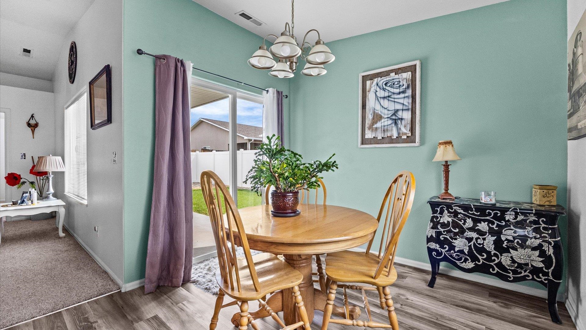 420-29 29 1/2 Road Grand Junction, CO 81504 - Photo 9 of 26 a view of a dining room with furniture and a chandelier