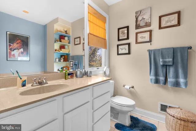 a kitchen with stainless steel appliances a sink cabinets and a window