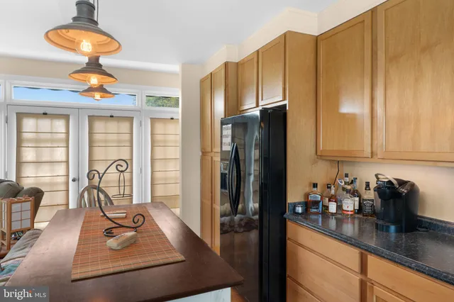 a view of an empty room and chandelier fan
