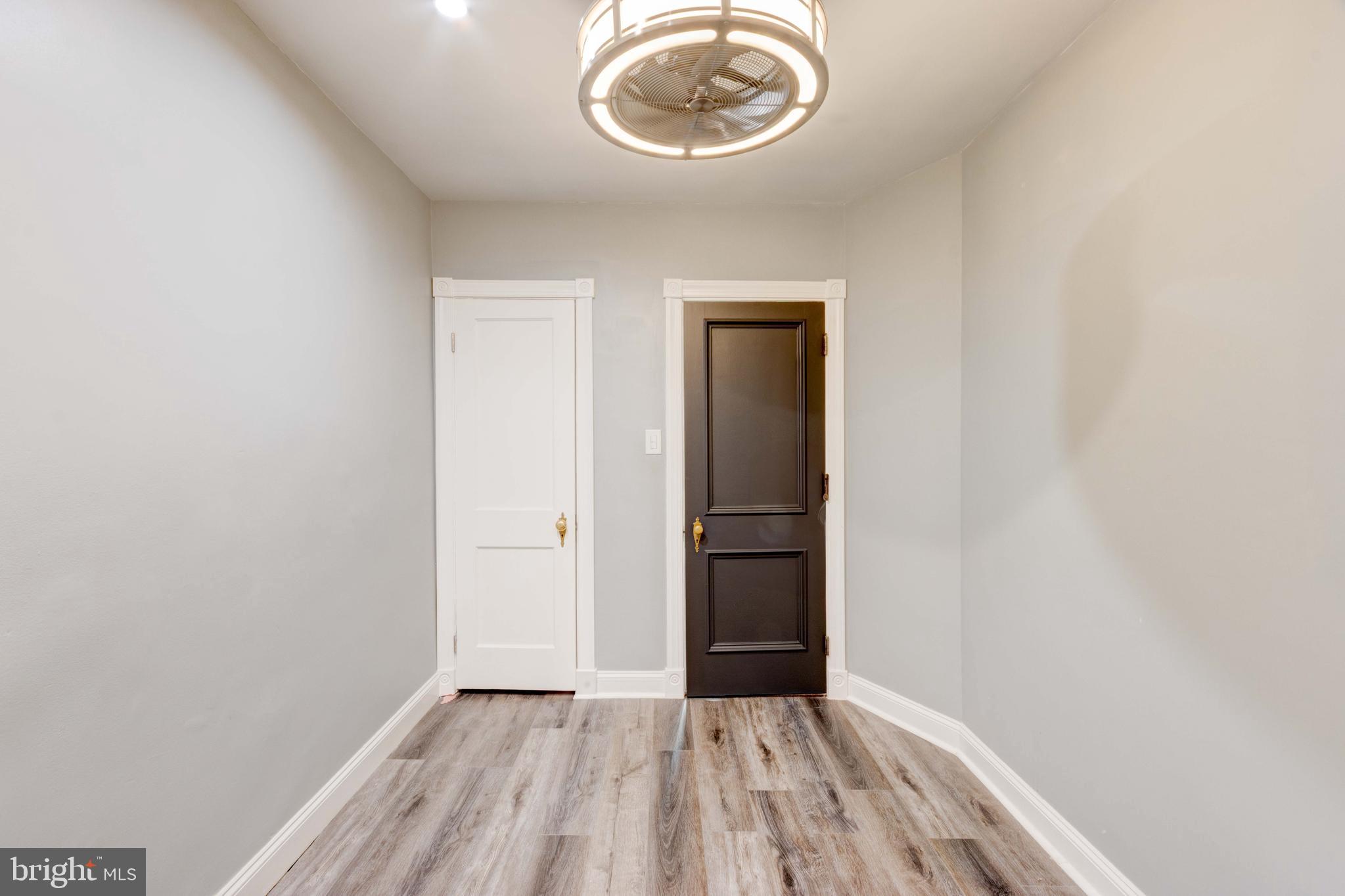 127 Cherrydell Road Catonsville, MD 21228 - Photo 14 of 24 an empty room with a hardwood and ceiling fan