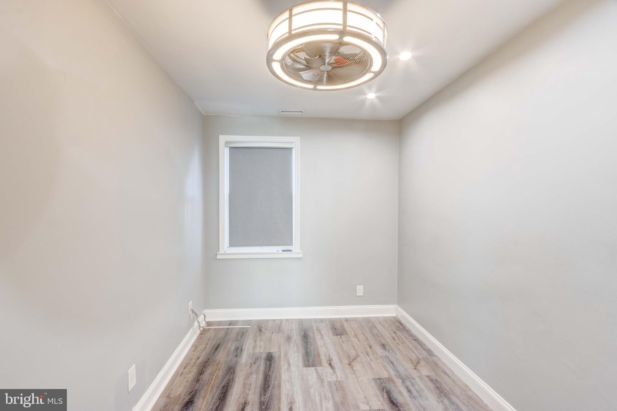 127 Cherrydell Road Catonsville, MD 21228 - Photo 15 of 24 an empty room with wooden floor and windows
