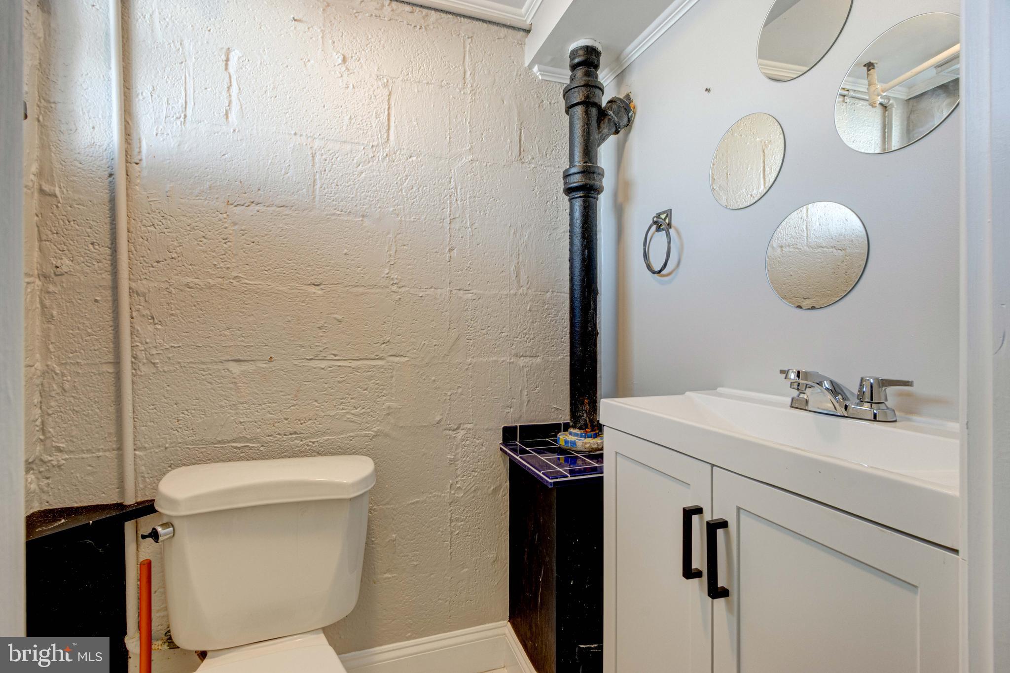 127 Cherrydell Road Catonsville, MD 21228 - Photo 20 of 24 a bathroom with a sink vanity mirror and toilet