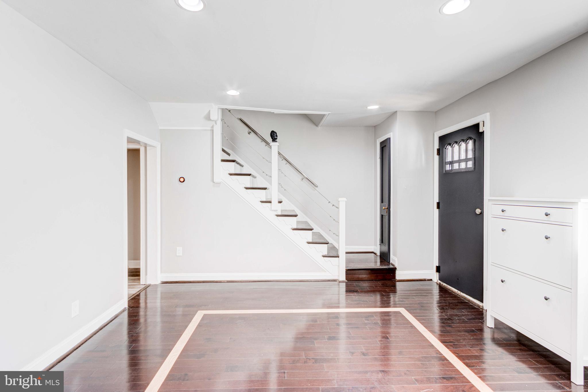127 Cherrydell Road Catonsville, MD 21228 - Photo 2 of 24 a view of staircase with white walls and a window