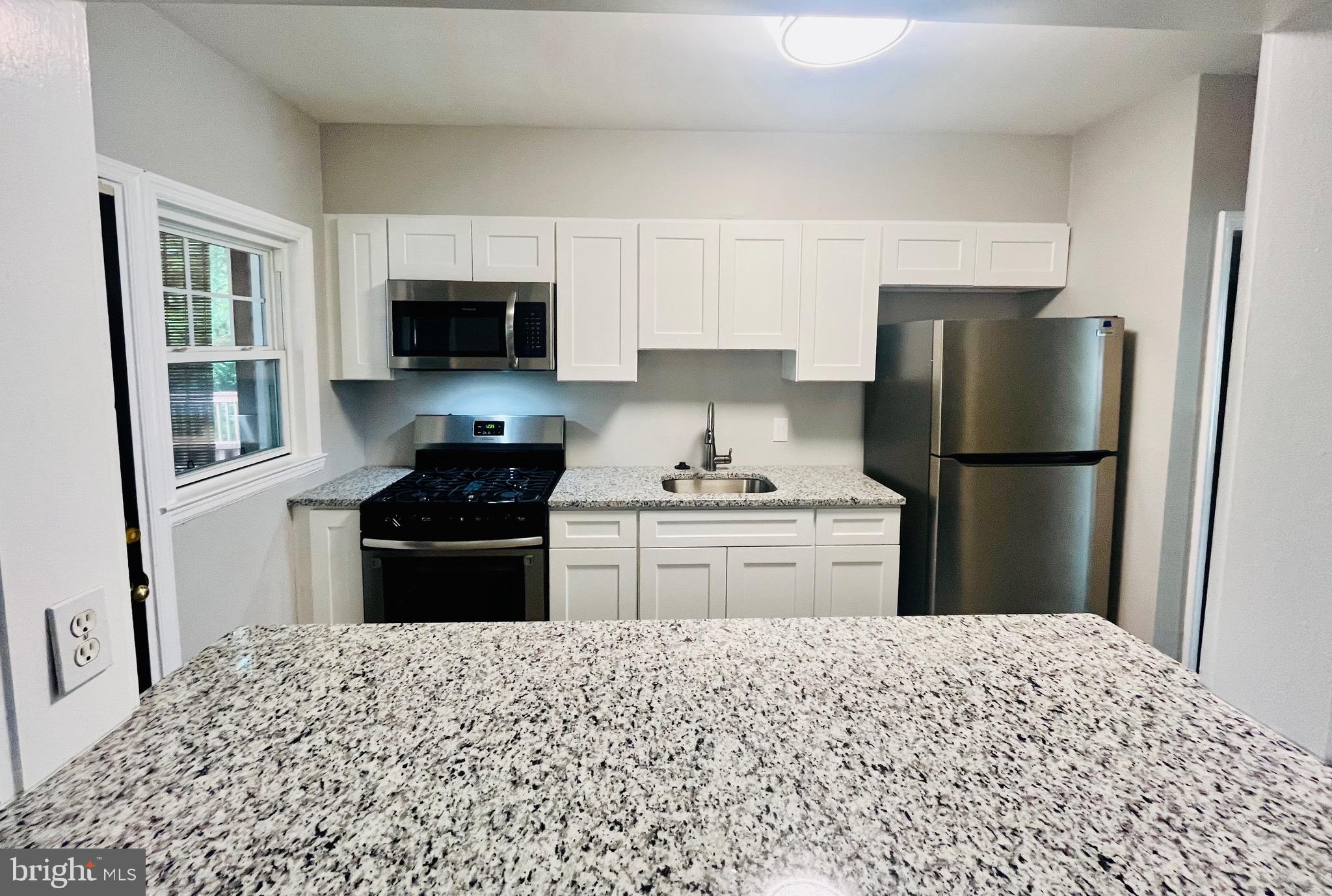127 Cherrydell Road Catonsville, MD 21228 - Photo 8 of 24 a kitchen with a refrigerator stove and microwave
