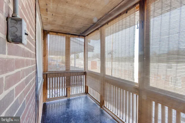 a view of a room with wooden floor and windows