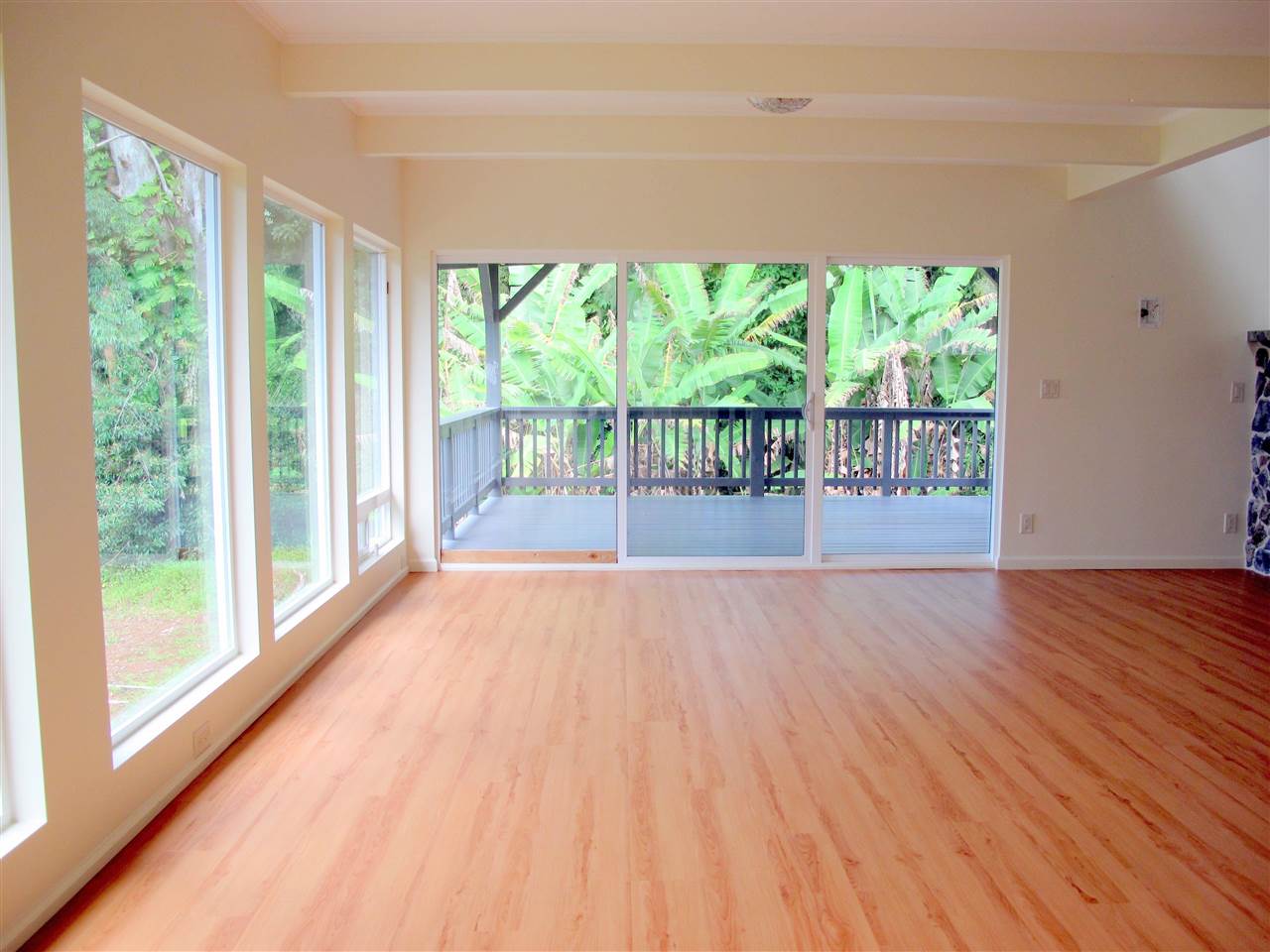 303 Waipalani Road Haiku, HI 96708 - Photo 13 of 29 a view of an empty room with wooden floor and a window