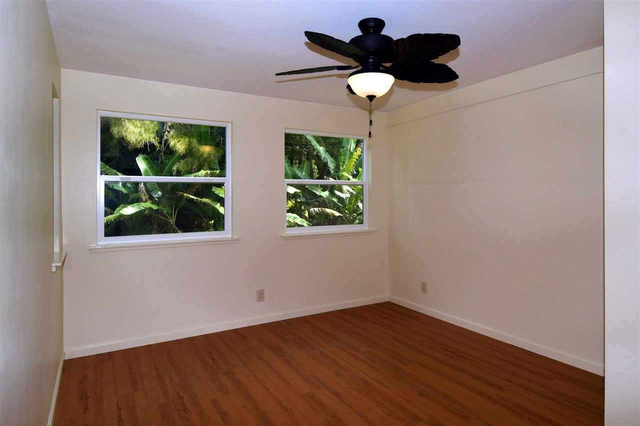 303 Waipalani Road Haiku, HI 96708 - Photo 14 of 29 a view of an empty room with wooden floor and a window