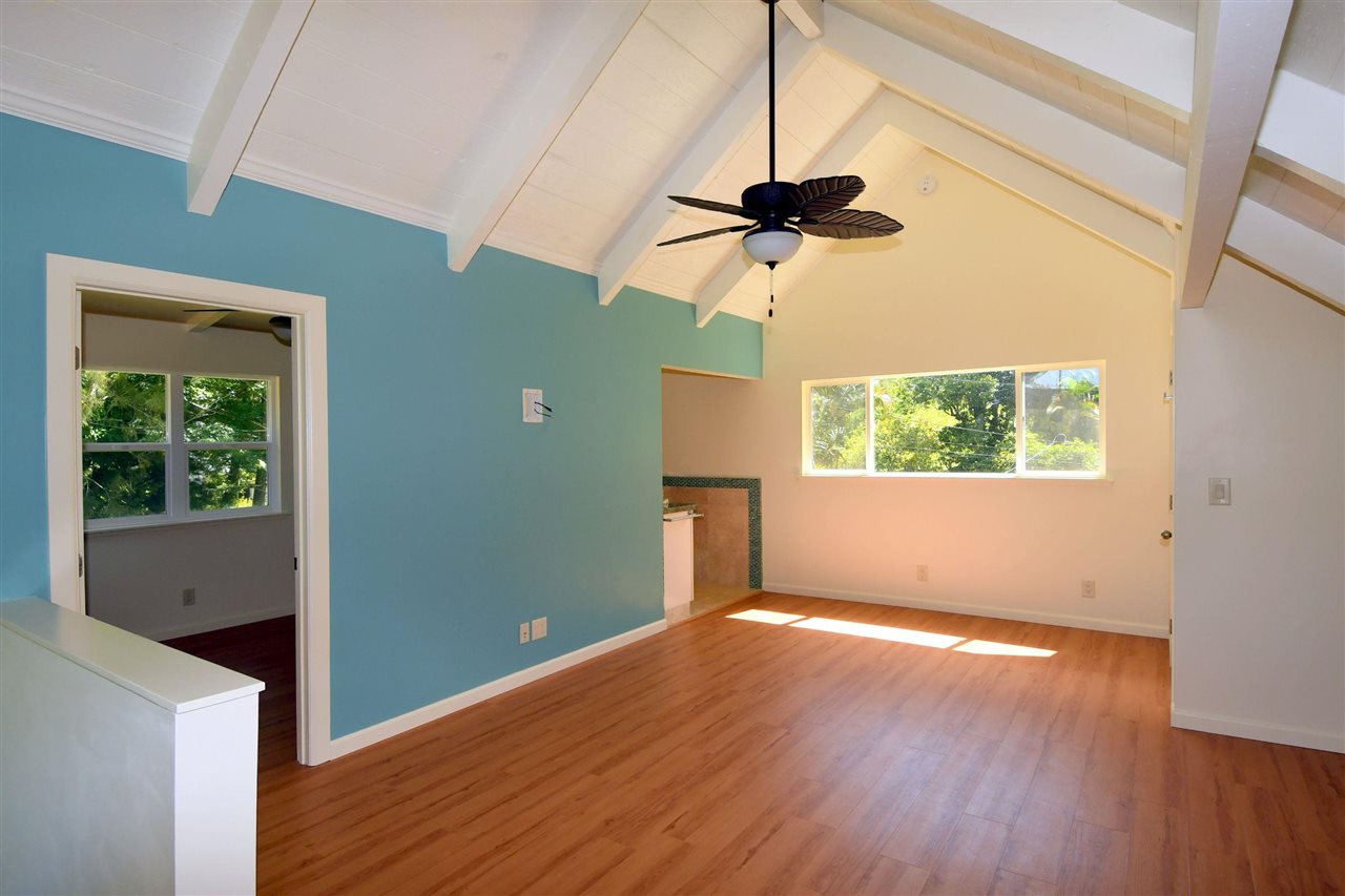 303 Waipalani Road Haiku, HI 96708 - Photo 16 of 29 an empty room with wooden floor cabinet and windows