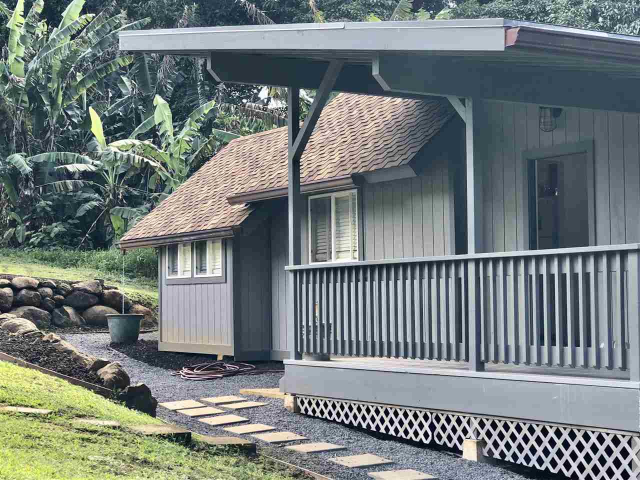 303 Waipalani Road Haiku, HI 96708 - Photo 21 of 29 a view of a wooden house with a yard