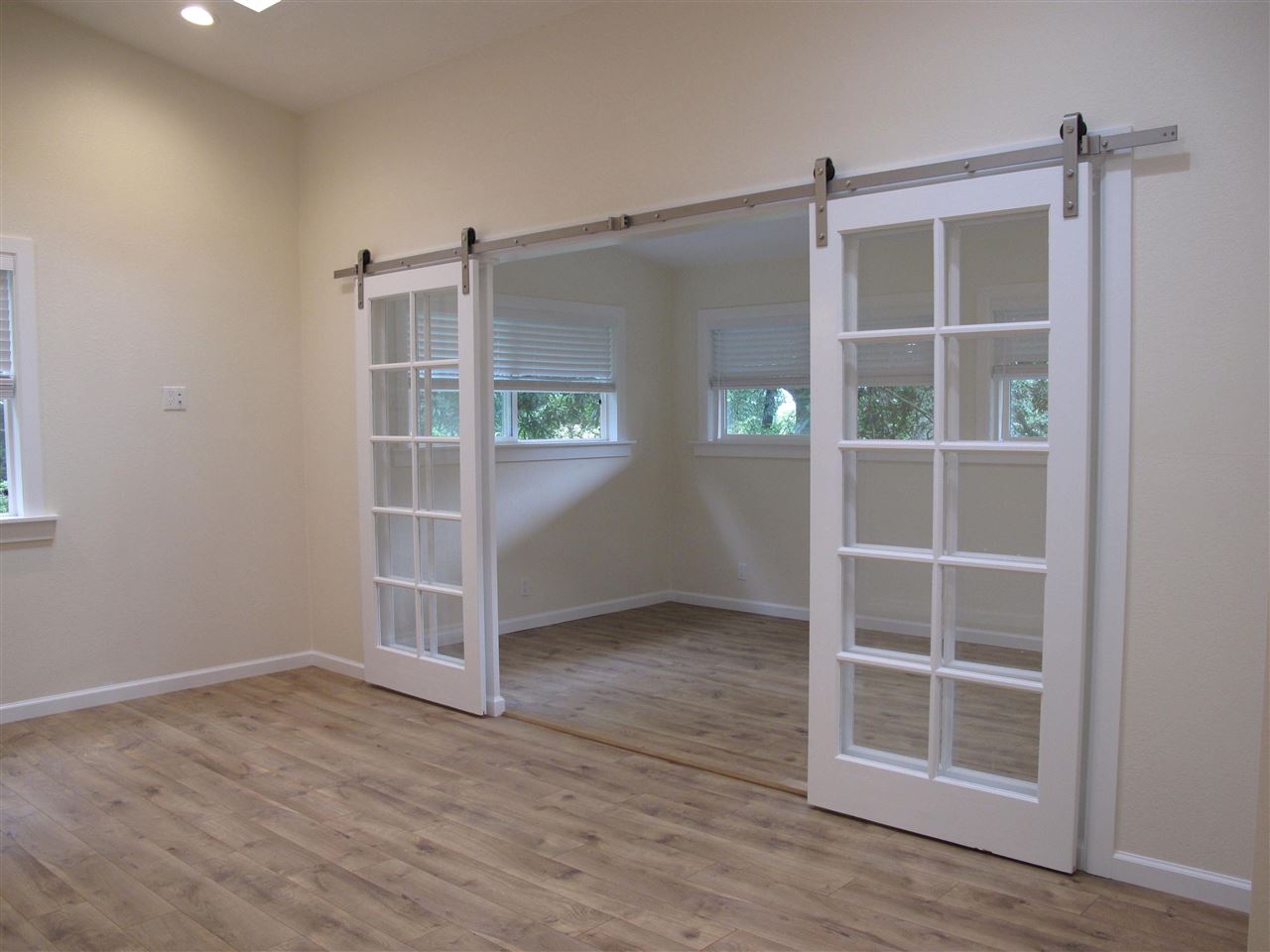 303 Waipalani Road Haiku, HI 96708 - Photo 26 of 29 an empty room with wooden floor and windows