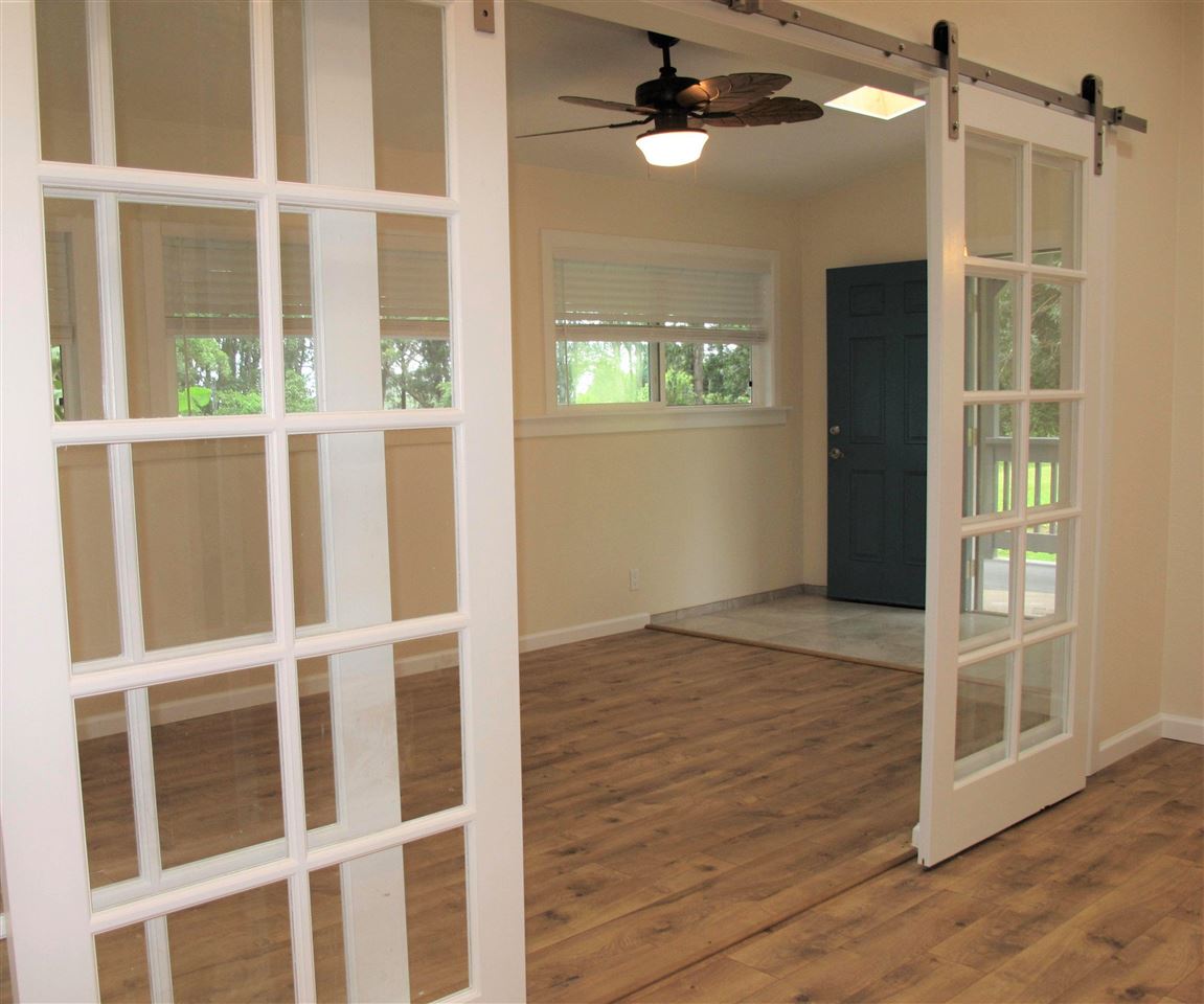 303 Waipalani Road Haiku, HI 96708 - Photo 27 of 29 a view of an empty room with wooden floor and a window