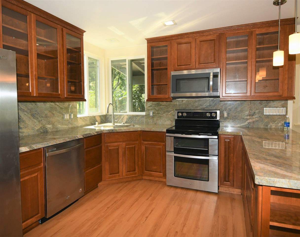 303 Waipalani Road Haiku, HI 96708 - Photo 6 of 29 a kitchen with stainless steel appliances granite countertop a stove a sink and a microwave