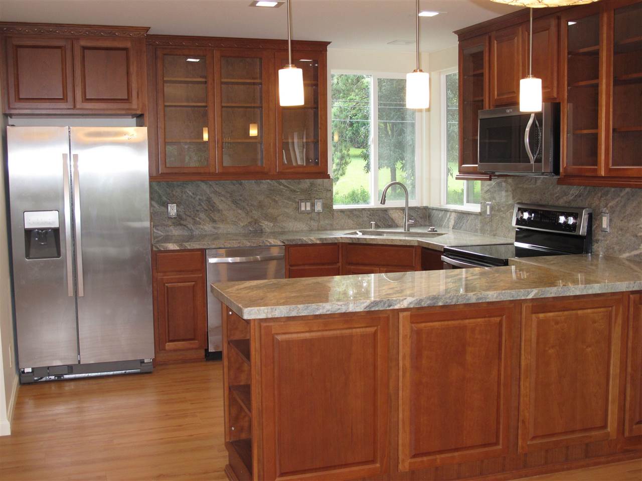 303 Waipalani Road Haiku, HI 96708 - Photo 7 of 29 a kitchen with stainless steel appliances granite countertop a sink a stove and a refrigerator